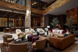 a lobby with couches and chairs and a bar at Archer Hotel Napa in Napa