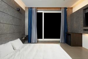 Postel nebo postele na pokoji v ubytování Elren Hotel Jeju