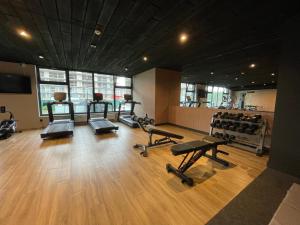 a gym with several treadmills and dumbbells in a room at Blue Dunes Apartament Polanki Aqua in Kołobrzeg