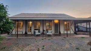 a house with a conservatory with a table and chairs at Reel in Serenity - Peaceful Beach Fishing Awaits in Onslow