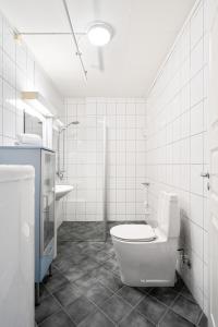 a white bathroom with a toilet and a sink at Enter Amalie Apartment Hotel in Tromsø
