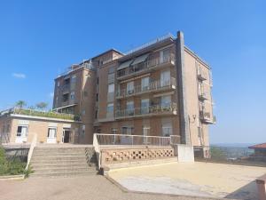 a large building with stairs in front of it at AGLIANO LOVELY APARTMENT in Agliano Terme