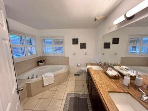 a large bathroom with a tub and a sink at Spacious Detached House in Mississauga in Mississauga