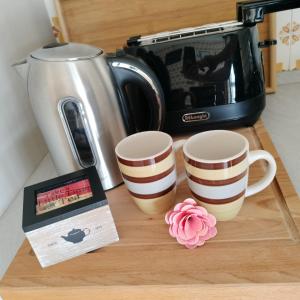 a counter with two coffee cups and a toaster at Casavacanze Sottocolle in Valmorea