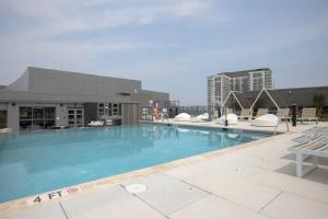 a large swimming pool on top of a building at Pentagon City 1br w pool gym nr downtown WDC-696 in Arlington