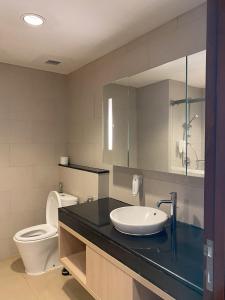 a bathroom with a sink and a toilet at 1 Bedroom Executive Suite apartment at The H Tower Kuningan Jakarta by Lorenso in Jakarta