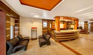 a salon with leather chairs and a mirror at Treebo Trend Sam Residency in Coimbatore