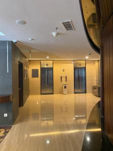 a hallway of a building with several elevators in it at 1 Bedroom Executive Suite apartment at The H Tower Kuningan Jakarta by Lorenso in Jakarta