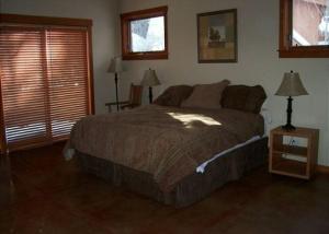 a bedroom with a large bed and two windows at Rr-carson_view1 Strap18-005 in June Lake