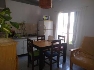 a kitchen with a table and chairs and a refrigerator at Casa familiar cerca de las termas in Dolores
