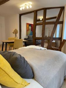 a bedroom with a large bed and a living room at Bording Appartment La Romantica in Fulda