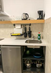 a kitchen counter with a sink and pots and pans at Apartamentos La Ruta in Calpe