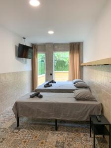 a bedroom with two beds and a large window at Apartamentos La Ruta in Calpe