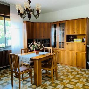 comedor con mesa de madera y sillas en Casavacanze Sottocolle, en Valmorea