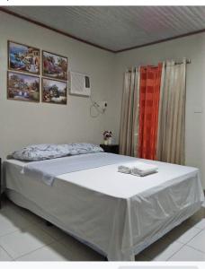 a bedroom with a large bed with a red window at Dalindas Homestay in Puerto Princesa City