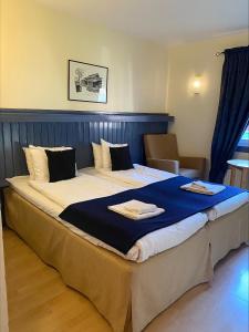 Postel nebo postele na pokoji v ubytování First Camp Moraparken Hotel