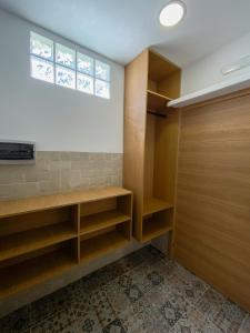 a walk in closet with wooden shelves and a window at Apartamentos La Ruta in Calpe
