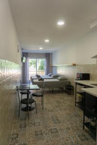 a room with several beds and tables and chairs at Apartamentos La Ruta in Calpe