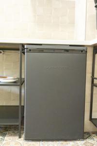 a dishwasher under a counter in a kitchen at Apartamentos La Ruta in Calpe