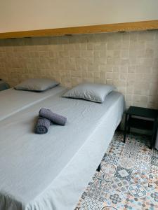 a bed with two pillows on it in a room at Apartamentos La Ruta in Calpe