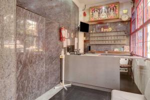 a kitchen with a counter and a sink at Collection O Sabharwal Inn in Bangalore