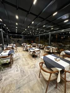 a restaurant with tables and chairs in a room at Noah's Ark Cave Hotel in Goreme