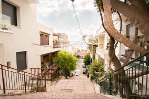 an empty street in a city with buildings at Chic Kastella Apt by Mikrolimano in Piraeus