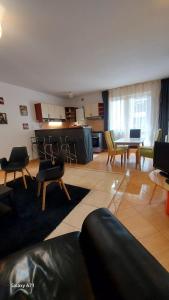 a large living room with chairs and a table at Apartament Roland in Poiana Brasov