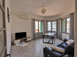 a living room with a couch and a table at Le Glacis in Collioure