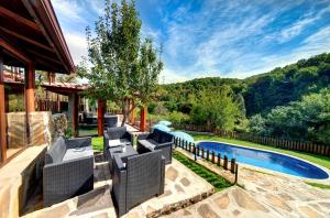 a backyard with a swimming pool and a house at House Maya in Tryavna