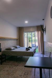 a room with two beds and a table in it at Apartamentos La Ruta in Calpe