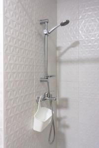 a shower with a shower head in a bathroom at Apartamentos La Ruta in Calpe