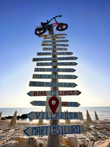 a sign on the beach with a motorcycle on it at Hotel Holiday in Martinsicuro +34 photos
