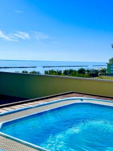 a swimming pool with a view of the ocean at Hotel Holiday in Martinsicuro