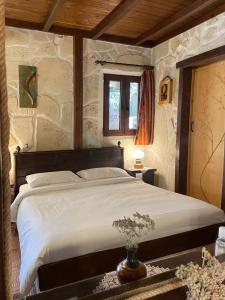 a bedroom with a large bed in a stone wall at Studios Stella & Stella's Traditional in Kato Zakros