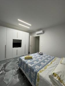 een slaapkamer met een groot bed met een blauwe deken erop bij PMM HOUSE in Librizzi