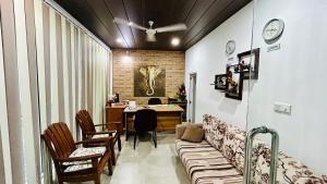 a room with a table and chairs and a desk at Salubrious Resort in Anuradhapura