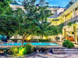 a courtyard with a swimming pool in a building at Salubrious Resort in Anuradhapura