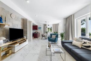 a living room with a couch and a tv at Villa Seraphina in Zaton