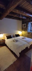 a large bedroom with two large beds in it at CABAÑA VENTO NORTE in Vilamós