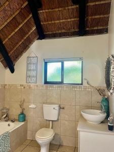 a bathroom with a toilet and a sink at Anchor Drift in St Francis Bay
