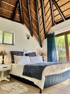a bedroom with a bed and a large window at Anchor Drift in St Francis Bay