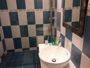 a bathroom with a white sink and a mirror at Camera tip economic Mozart in Cluj-Napoca