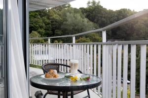 a table with a plate of food on a balcony at Art City Inn in Vilnius