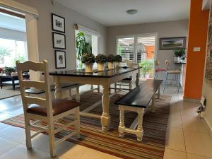 a dining room with a table and a chair at 19 Richthofen in Swakopmund