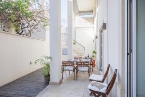 an internal courtyard with a table and chairs in a house at Lisbon Sunny Terrace Lapa Santos in Lisbon