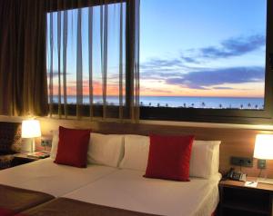 a bedroom with a bed with a view of the ocean at Hotel Best 4 Barcelona in Barcelona