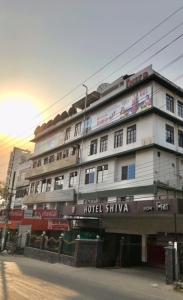 a large white building on the side of a street at HOTEL SHIVA in Guwahati