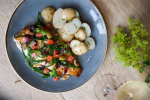 a blue plate with a piece of pizza and potatoes at The White Hart, Overton in Overton