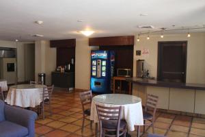 a restaurant with two tables and a soda machine at Red Roof Inn Pharr - McAllen in Pharr